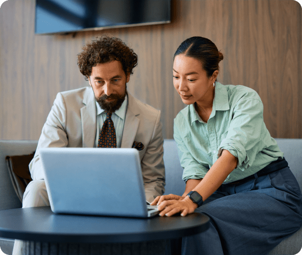Two colleagues collaborating on a laptop